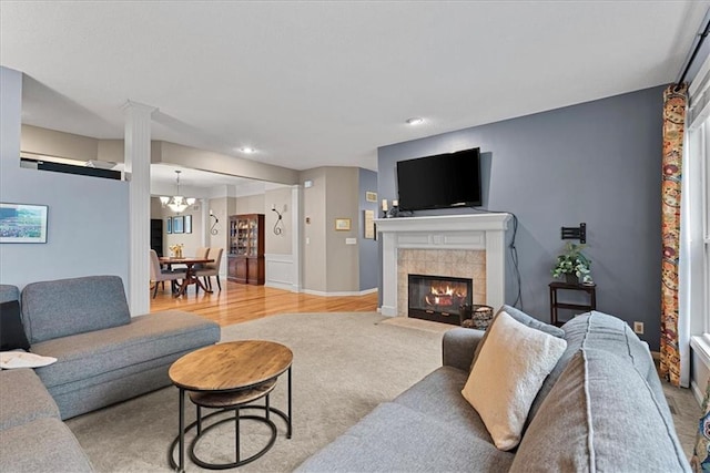 living room featuring a tile fireplace, wood finished floors, recessed lighting, and baseboards