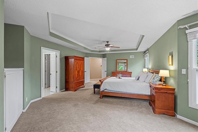 bedroom with carpet, a raised ceiling, baseboards, and ceiling fan