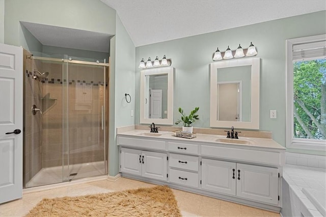 full bathroom featuring a shower stall, double vanity, tile patterned floors, and a tub to relax in
