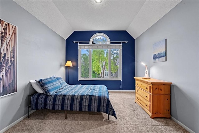 bedroom featuring carpet flooring, a textured ceiling, lofted ceiling, and baseboards