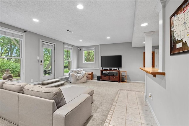 living room featuring recessed lighting, a textured ceiling, plenty of natural light, carpet, and tile patterned flooring