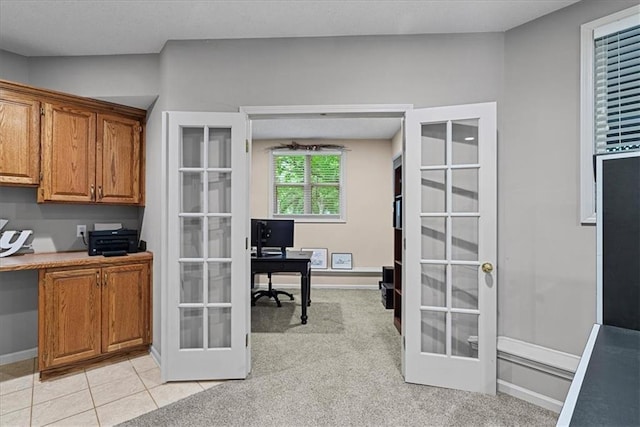 home office with french doors, baseboards, and light tile patterned flooring
