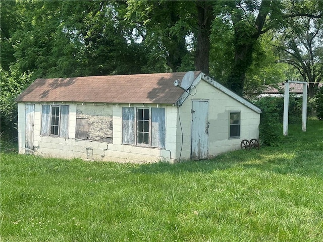 218 S Kent St, Excelsior Springs, MO 64024 - view of side of property with concrete block siding, a lawn, and roof with shingles