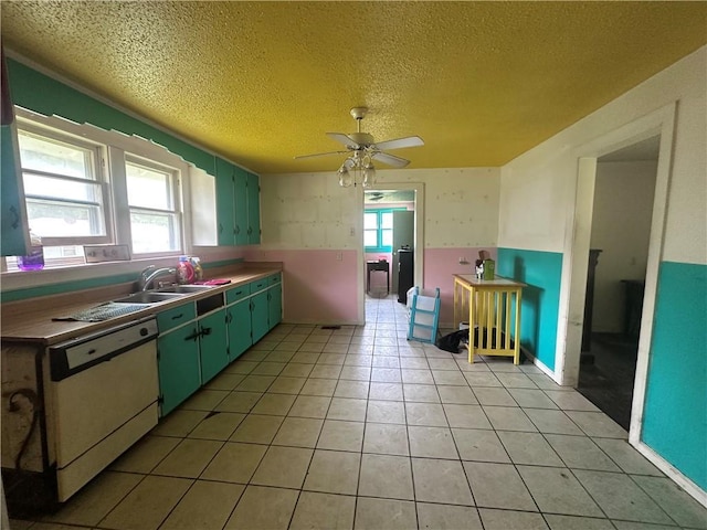 218 S Kent St, Excelsior Springs, MO 64024 - kitchen featuring dishwasher, a ceiling fan, a textured ceiling, a sink, and light tile patterned floors
