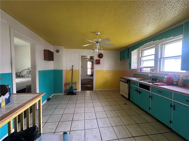218 S Kent St, Excelsior Springs, MO 64024 - kitchen with a sink, ceiling fan, a textured ceiling, dishwasher, and light tile patterned floors