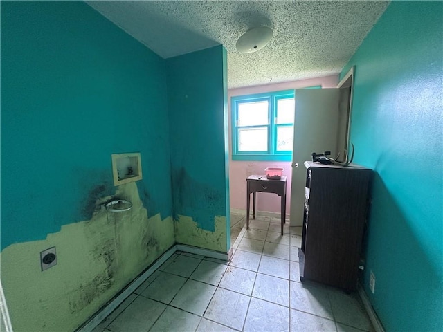 218 S Kent St, Excelsior Springs, MO 64024 - bathroom featuring a textured ceiling, tile patterned flooring, and baseboards