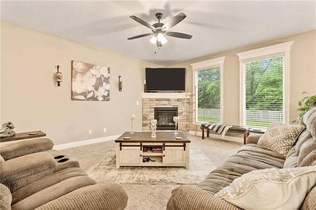 19625 E 18th Ter, Independence, MO 64057 - living area with carpet, ceiling fan, baseboards, and a stone fireplace