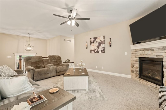 19625 E 18th Ter, Independence, MO 64057 - living area featuring light colored carpet, a ceiling fan, a fireplace, baseboards, and a chandelier
