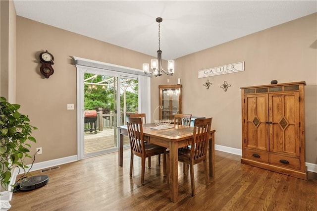 19625 E 18th Ter, Independence, MO 64057 - dining area with a chandelier, dark wood-style floors, and baseboards
