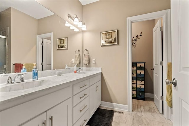 19625 E 18th Ter, Independence, MO 64057 - full bath with double vanity, marble look tiles, baseboards, and an enclosed shower