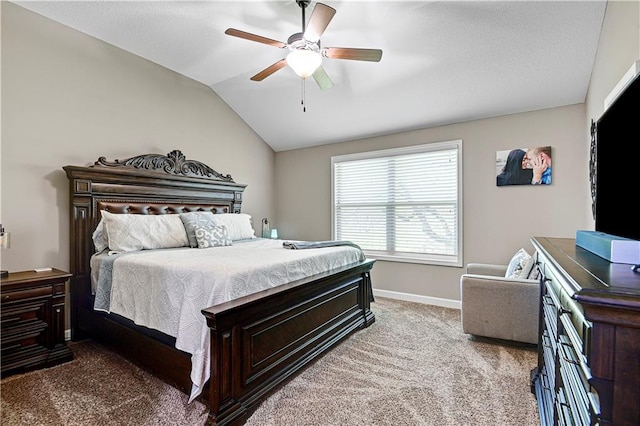 carpeted bedroom with vaulted ceiling, a ceiling fan, and baseboards