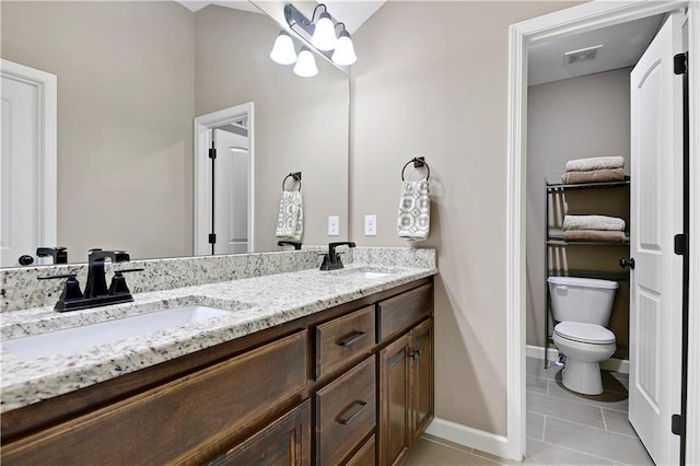 bathroom with tile patterned floors, visible vents, a sink, and toilet