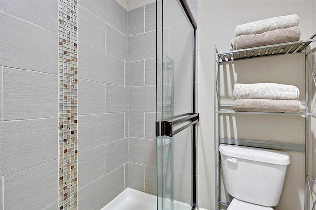 full bath featuring toilet and a stall shower
