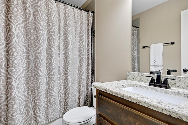 bathroom featuring toilet and vanity