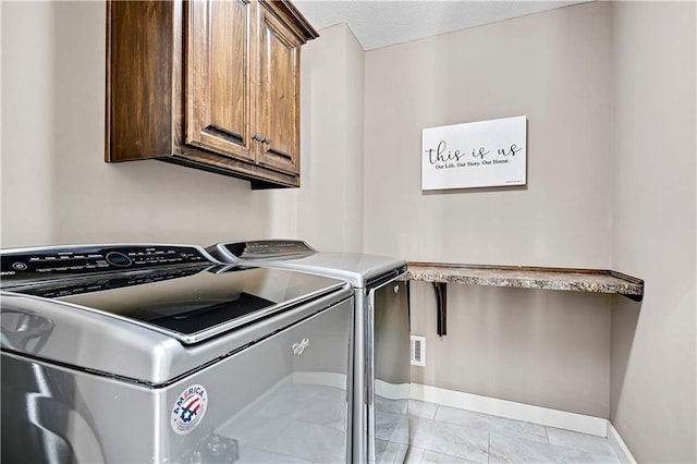 laundry room featuring washer and dryer, baseboards, cabinet space, and visible vents