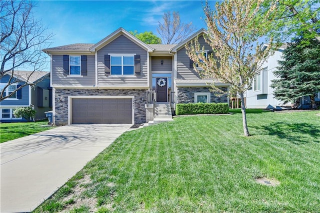 raised ranch featuring an attached garage, driveway, stone siding, and a front yard