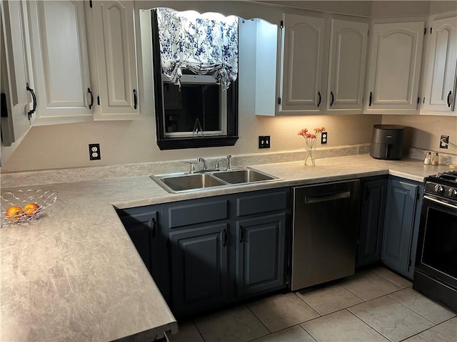 kitchen with a sink, light countertops, white cabinetry, and black gas stove