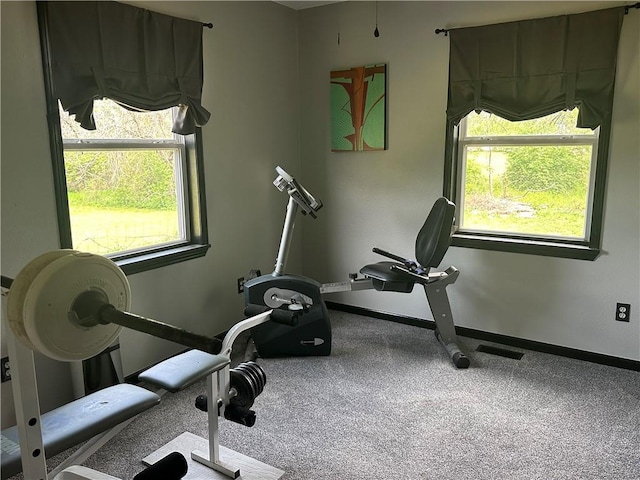 workout room with a wealth of natural light, visible vents, and baseboards