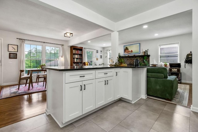 416 NE Carriage St, Lees Summit, MO 64064 - kitchen with dark countertops, white cabinets, baseboards, recessed lighting, and light tile patterned flooring