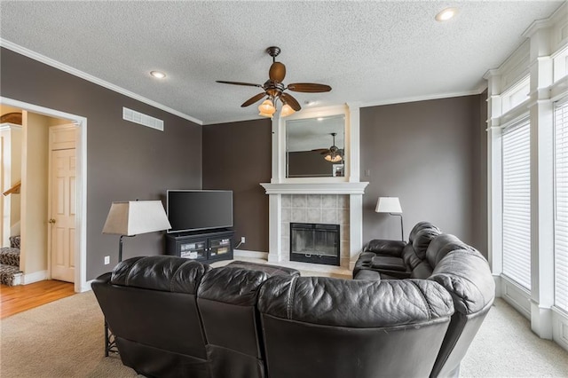 7428 N Smalley Ave, Kansas City, MO 64158 - living area with ceiling fan, a textured ceiling, a fireplace, ornamental molding, and baseboards