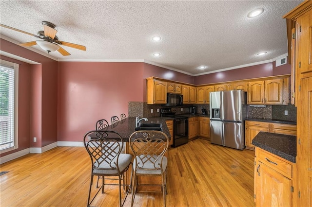 7428 N Smalley Ave, Kansas City, MO 64158 - kitchen with black appliances, a textured ceiling, ceiling fan, tasteful backsplash, and a peninsula