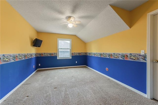 7428 N Smalley Ave, Kansas City, MO 64158 - additional living space featuring a ceiling fan, carpet, a textured ceiling, vaulted ceiling, and baseboards