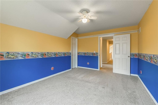 7428 N Smalley Ave, Kansas City, MO 64158 - unfurnished bedroom with carpet floors, lofted ceiling, baseboards, and a ceiling fan