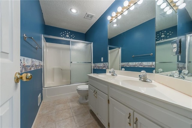 7428 N Smalley Ave, Kansas City, MO 64158 - full bath with a textured ceiling, double vanity, tile patterned flooring, toilet, and shower / bath combination with glass door