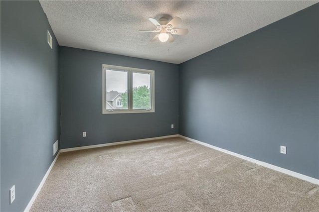 7428 N Smalley Ave, Kansas City, MO 64158 - empty room featuring a textured ceiling, ceiling fan, carpet, and baseboards