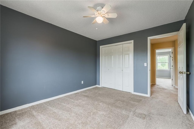 7428 N Smalley Ave, Kansas City, MO 64158 - unfurnished bedroom with carpet, a textured ceiling, a closet, baseboards, and a ceiling fan