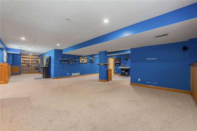 7428 N Smalley Ave, Kansas City, MO 64158 - unfurnished living room with carpet flooring, baseboards, a textured ceiling, and recessed lighting
