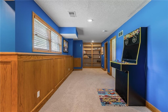 7428 N Smalley Ave, Kansas City, MO 64158 - hall featuring a textured ceiling, carpet, and wainscoting
