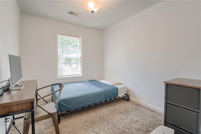bedroom featuring carpet, baseboards, and a desk