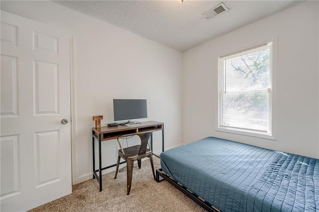 bedroom featuring light colored carpet and baseboards