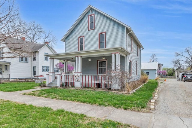 316 W 5th Ave, Garnett, KS 66032 - view of front of property with covered porch and a front lawn