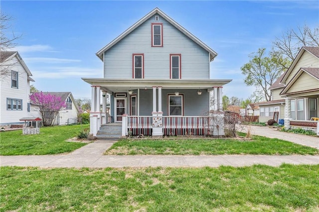 316 W 5th Ave, Garnett, KS 66032 - view of front of home featuring covered porch and a front lawn