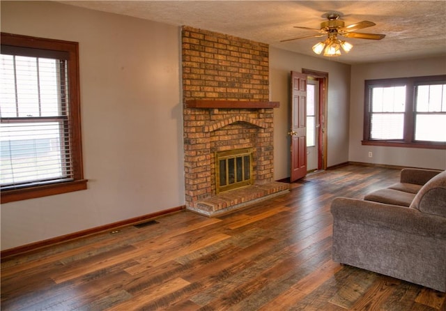 living area featuring hardwood / wood-style floors, baseboards, and a fireplace