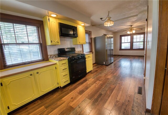 kitchen featuring tasteful backsplash, ceiling fan, light countertops, dark wood-type flooring, and black appliances