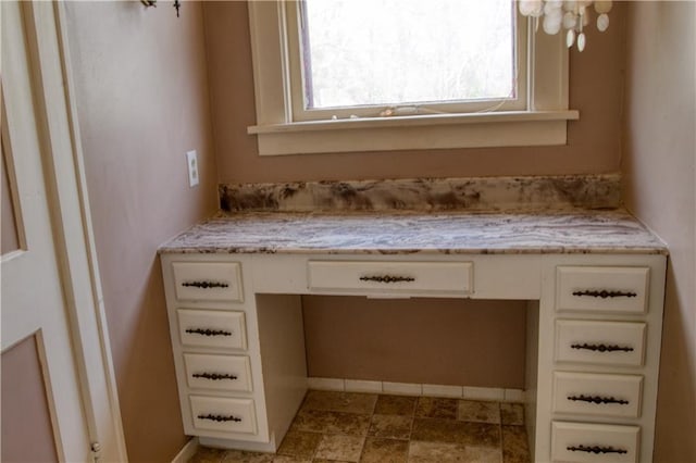 bathroom featuring baseboards and vanity