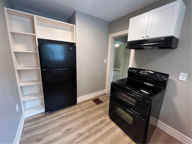 5702 Euclid Ave, Kansas City, MO 64130 - kitchen featuring black appliances, light wood finished floors, white cabinetry, under cabinet range hood, and visible vents