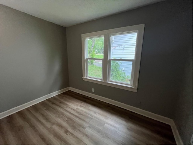 5702 Euclid Ave, Kansas City, MO 64130 - unfurnished room with wood finished floors and baseboards