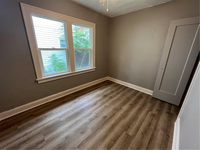 5702 Euclid Ave, Kansas City, MO 64130 - unfurnished room featuring baseboards and wood finished floors