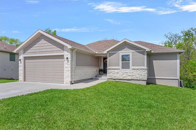 single story home with a front yard, roof with shingles, concrete driveway, an attached garage, and stone siding