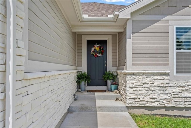 entrance to property featuring stone siding