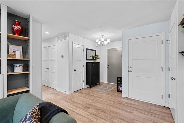 entrance foyer with visible vents, baseboards, recessed lighting, a chandelier, and light wood-style flooring
