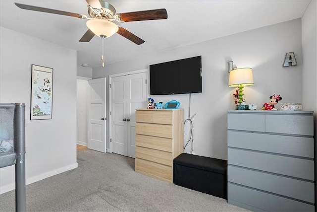 carpeted bedroom with baseboards and ceiling fan