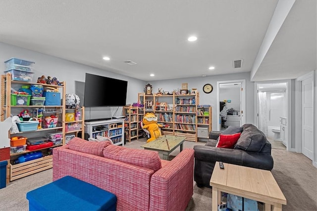 carpeted living area featuring recessed lighting and visible vents