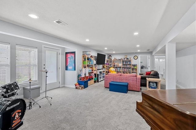 living area featuring baseboards, carpet, recessed lighting, and visible vents