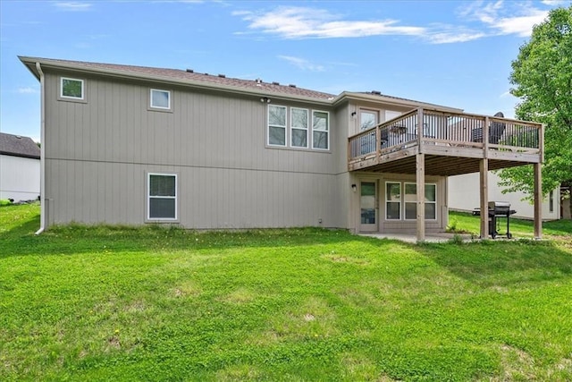 back of property featuring a yard and a deck