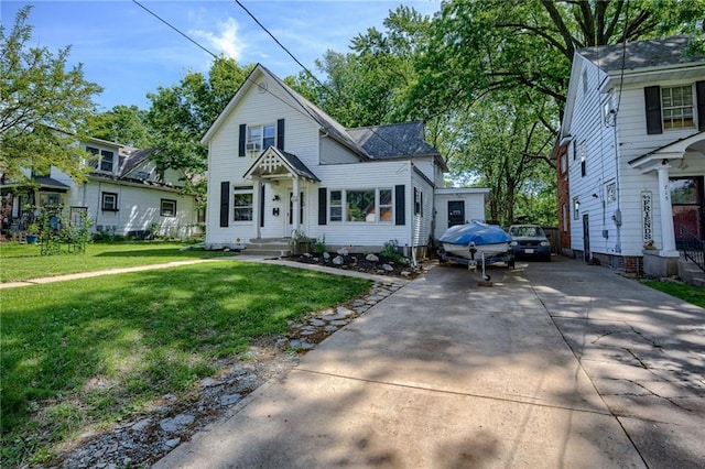 traditional-style home with driveway and a front yard